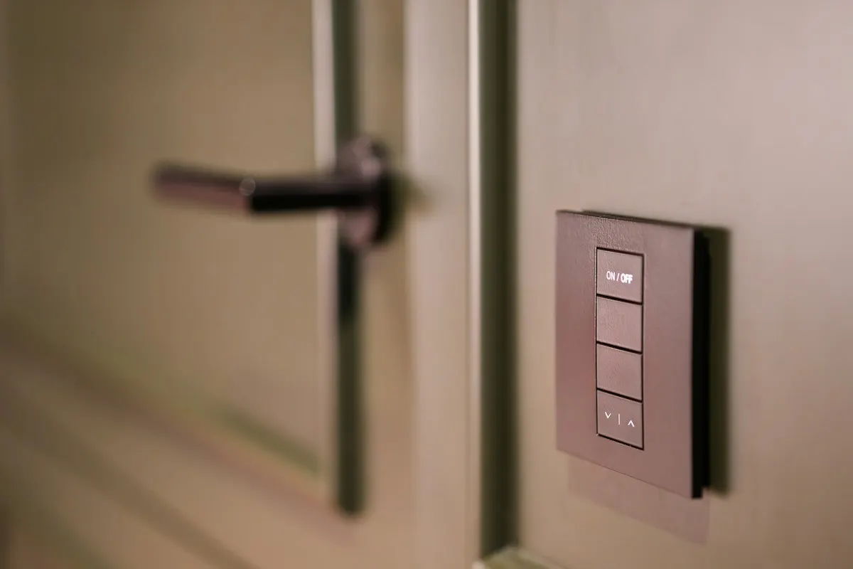 Wall-mounted lighting keypad beside a doorway