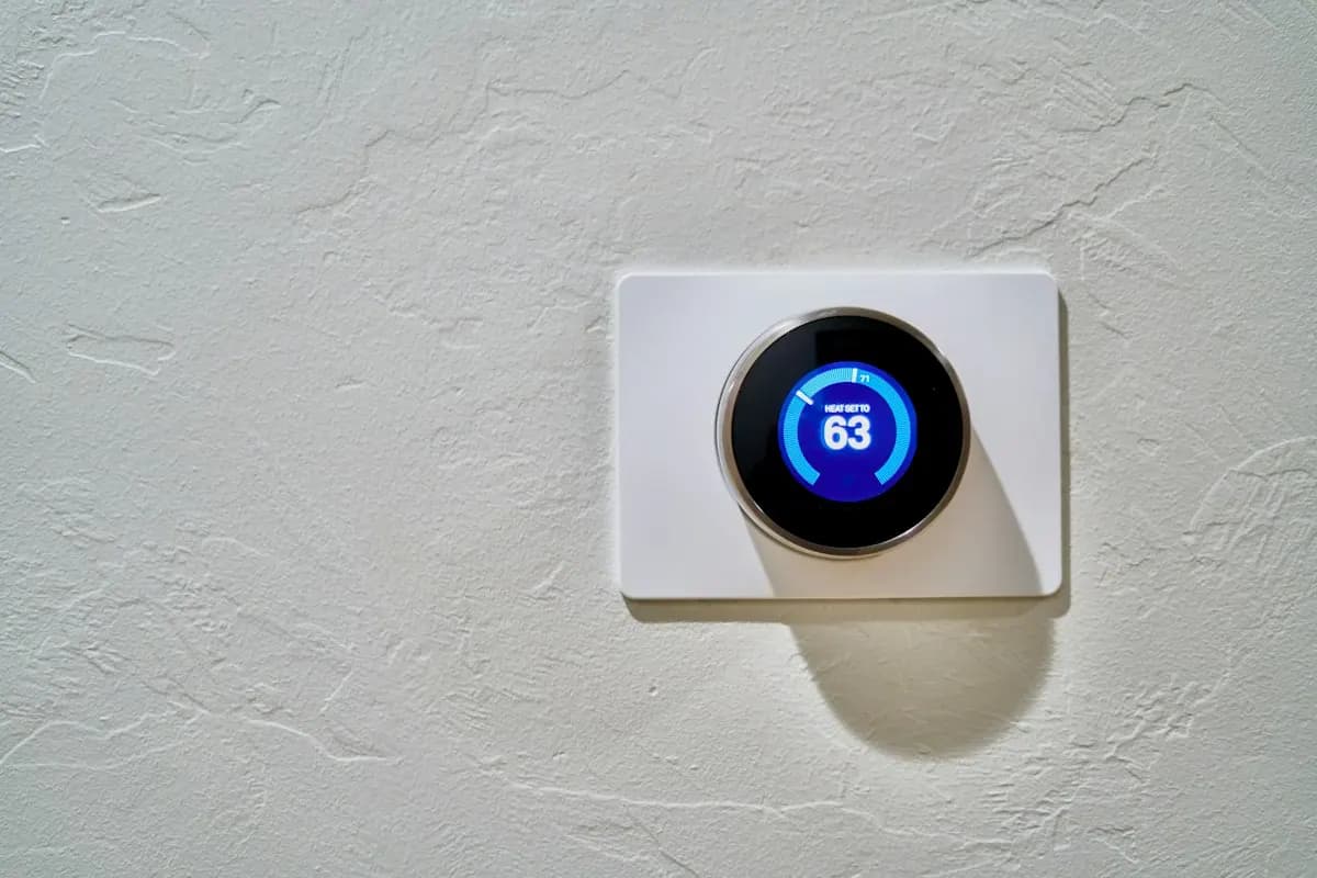 Digital thermostat set into a white wall plate